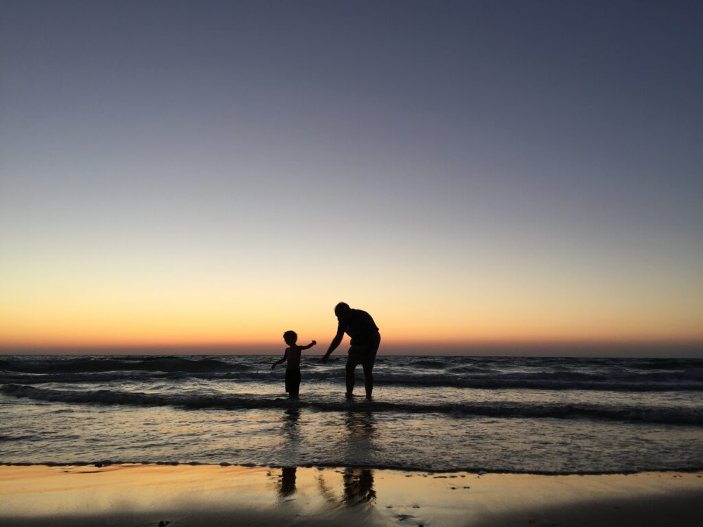 Man and child on beach